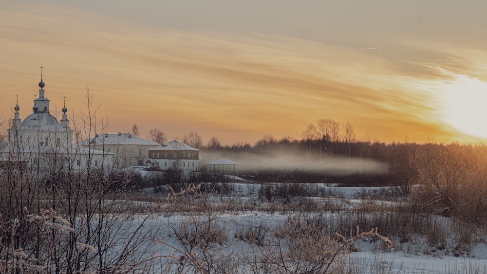 a snowy landscape with a church in the background