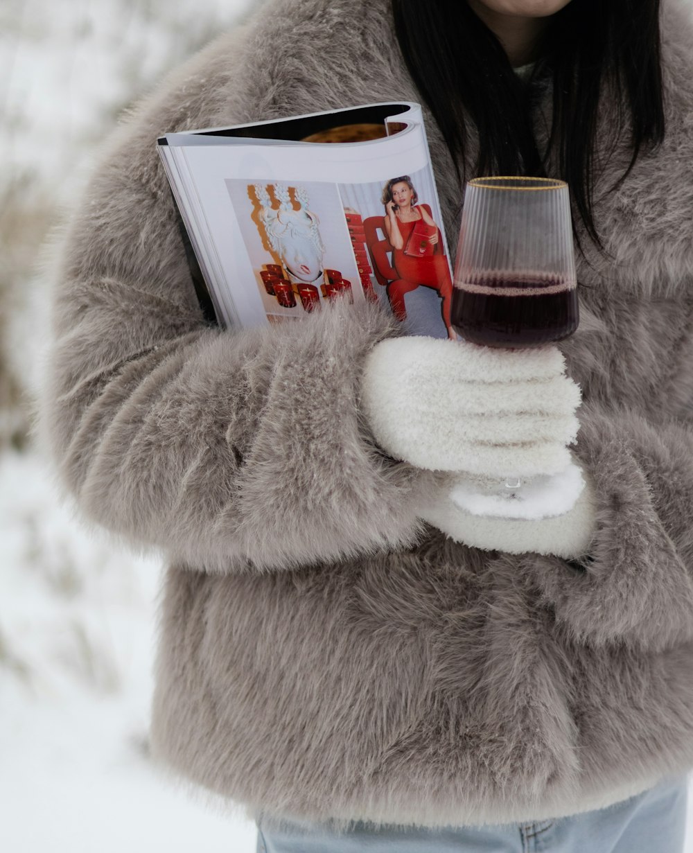 a woman in a fur coat holding a glass of wine