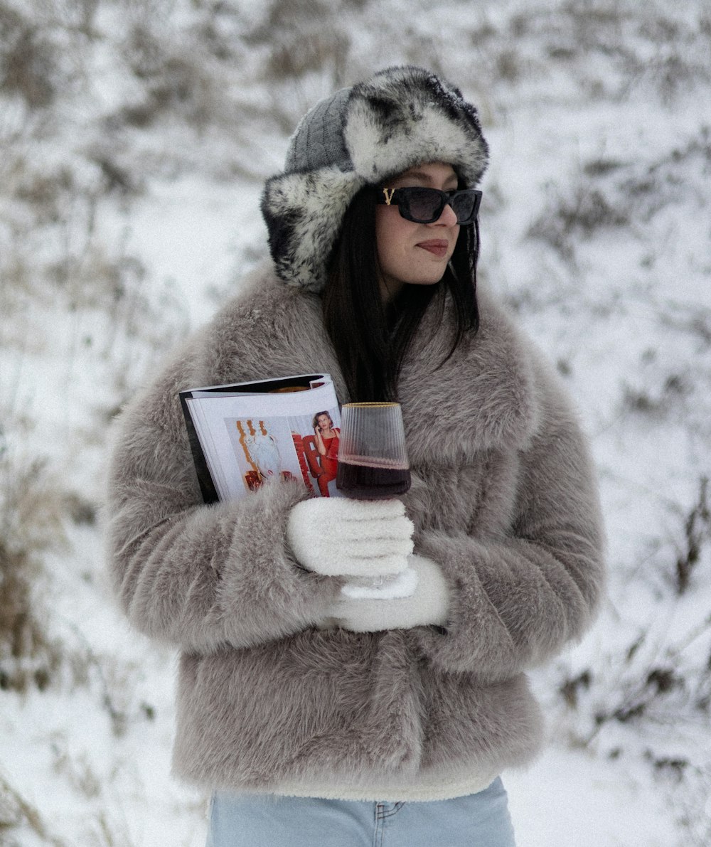 a woman in a fur coat holding a glass of wine