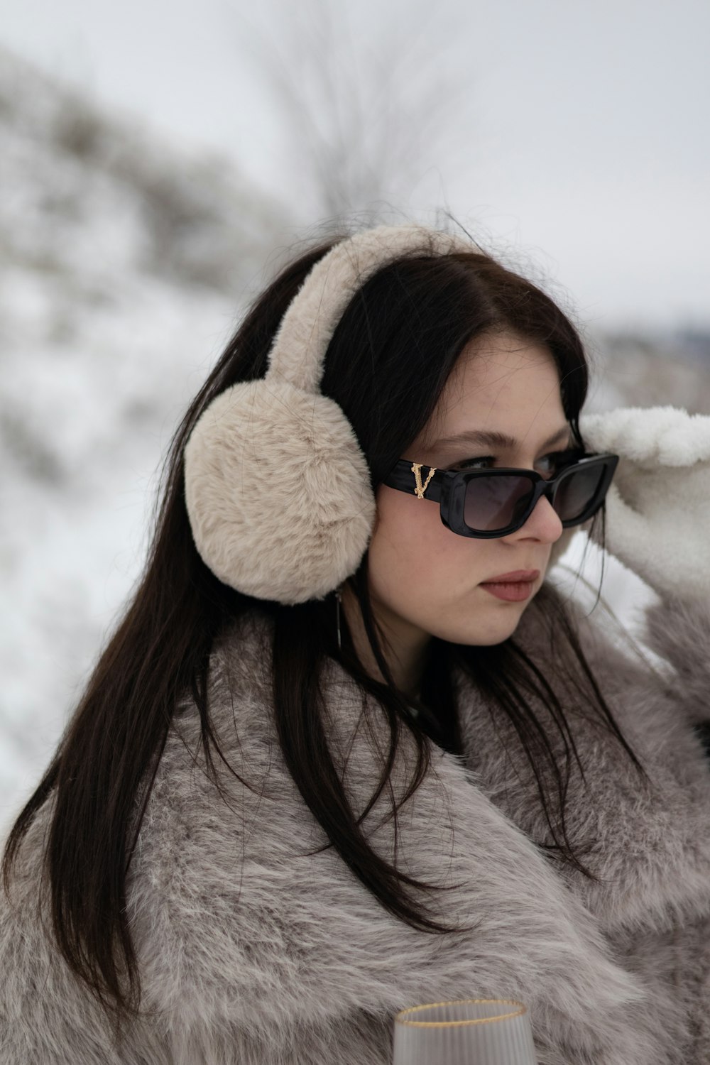 a woman wearing headphones and a fur coat