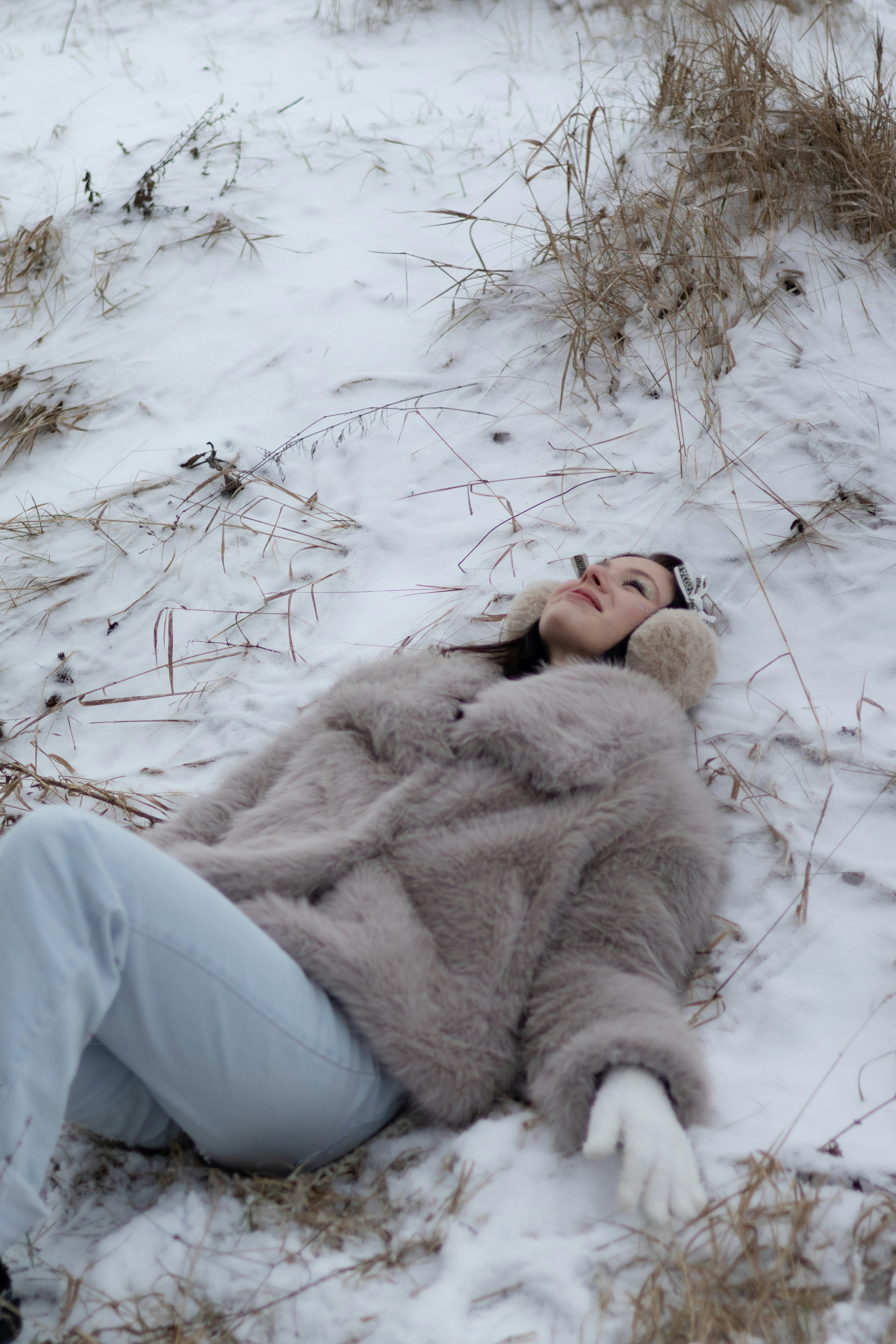 A woman laying in the snow with her eyes closed photo – Free Portrait ...