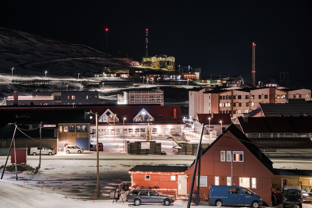 a night time view of a town with a mountain in the background