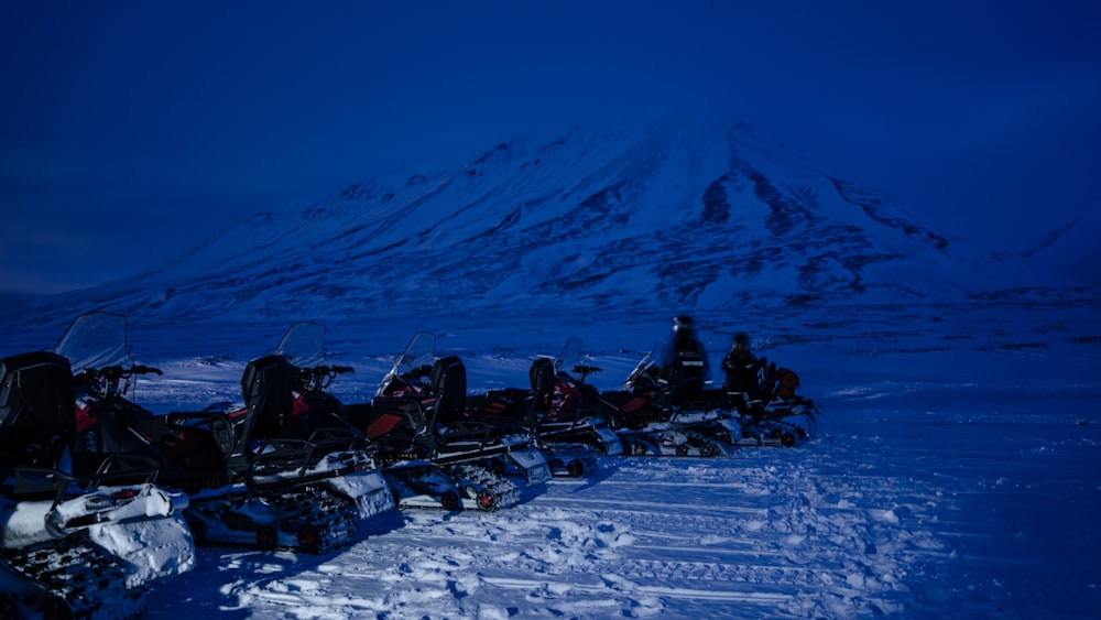 a group of snowmobiles parked in the snow