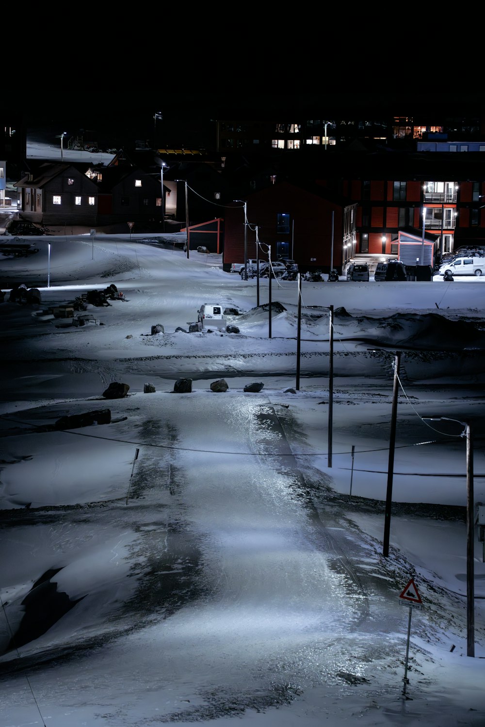 a street with snow on the ground and a building in the background