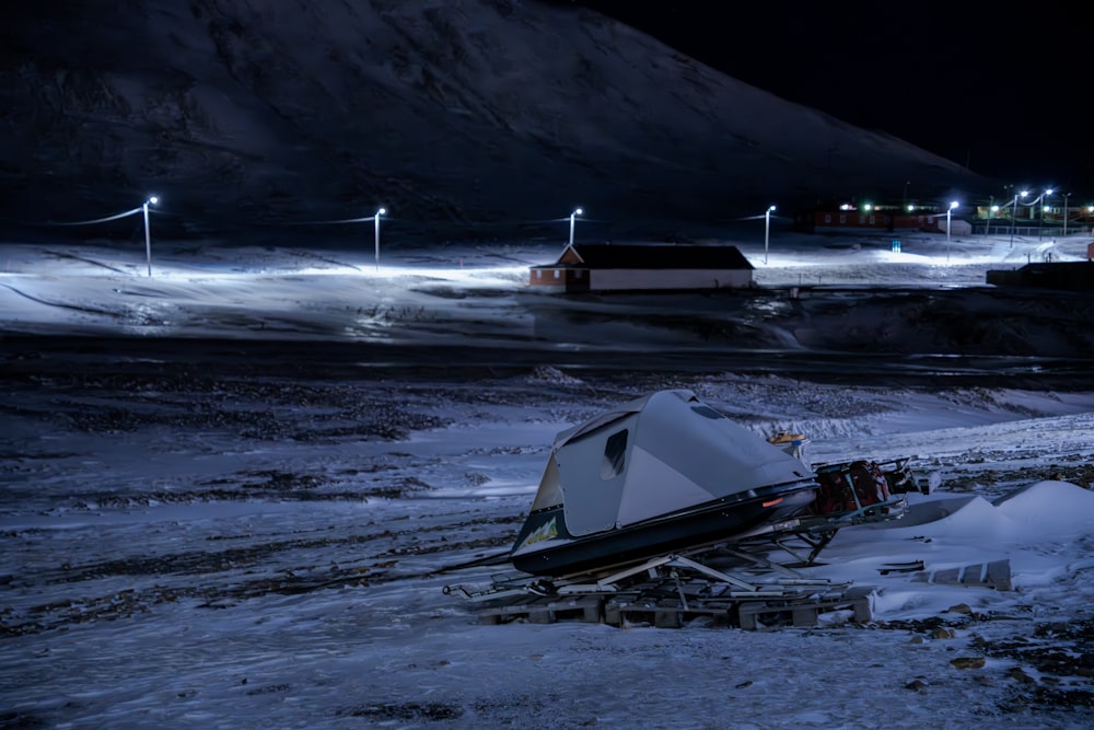 a camper sits in the middle of a snowy field