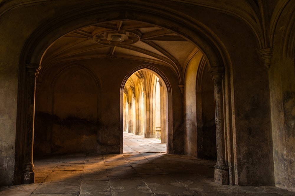 an archway leading into a building with stone floors