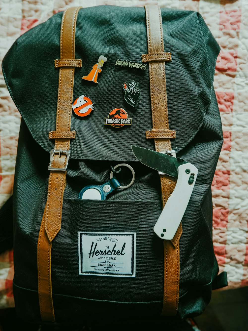 a backpack with a pair of scissors and a pair of scissors