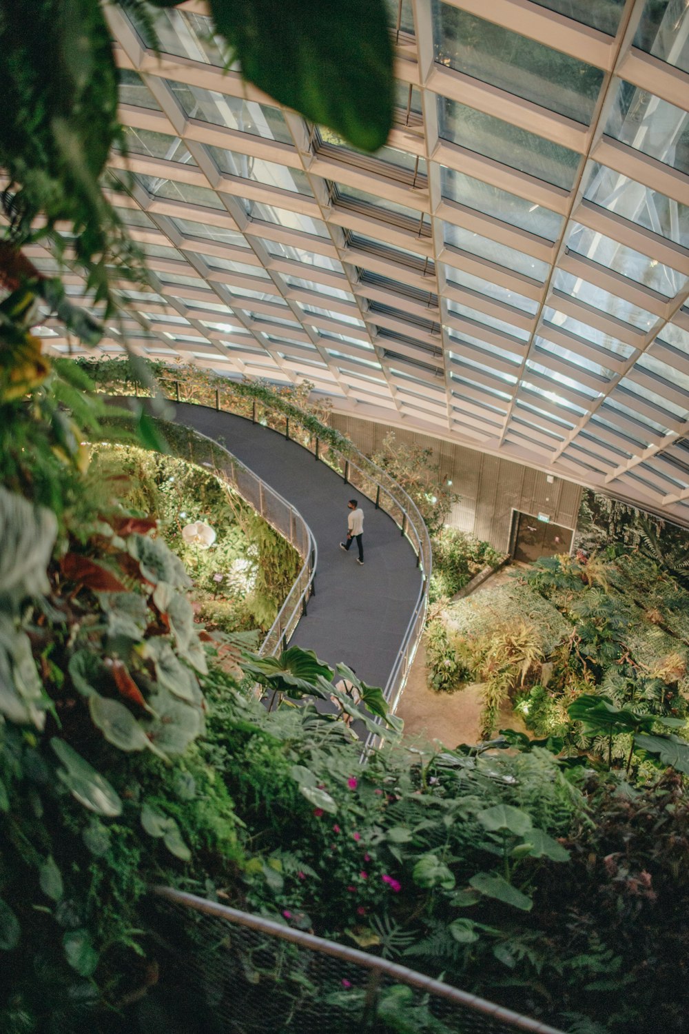 a man walking down a walkway in a building