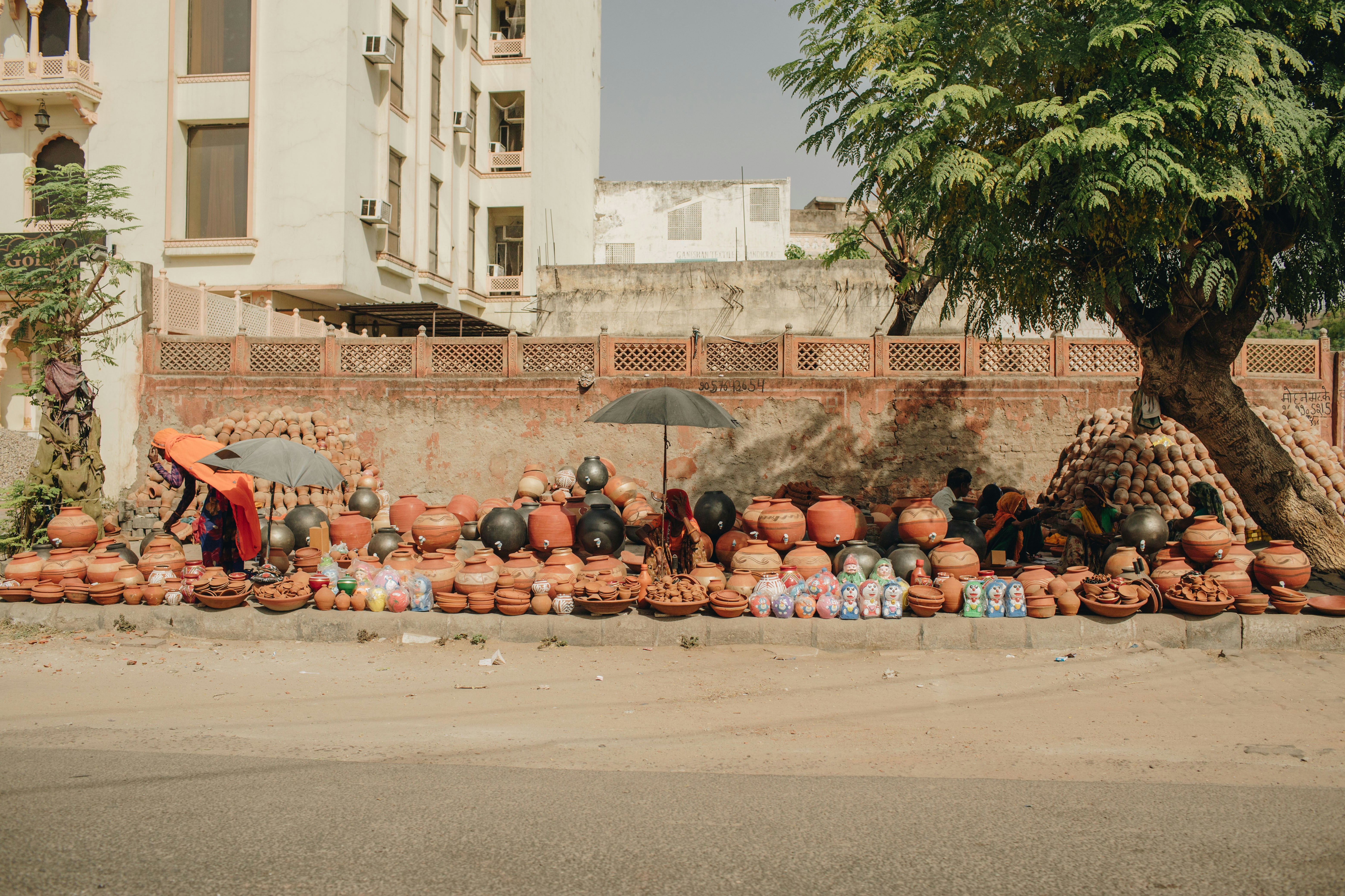 A group of clay pots sitting on the side of a road photo – Free India ...