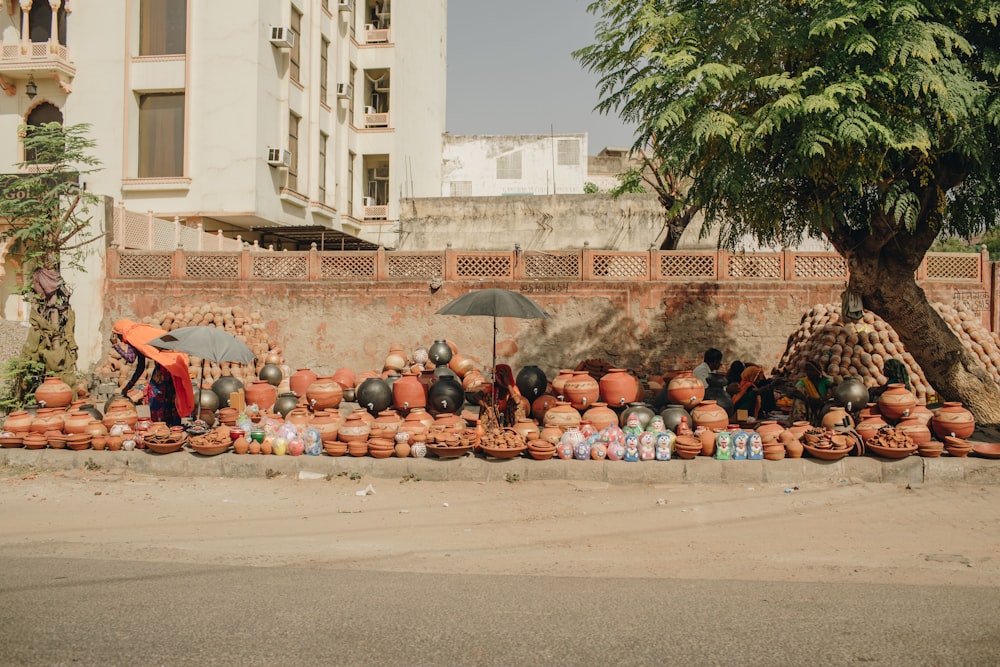 a group of clay pots sitting on the side of a road