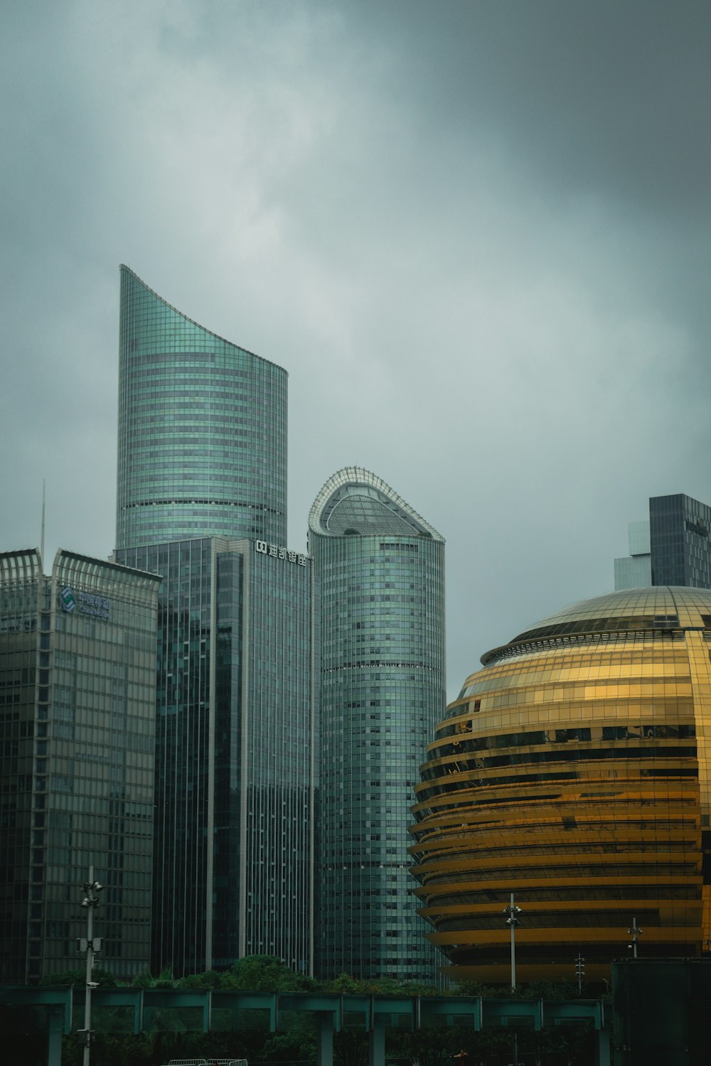 a city with a lot of tall buildings under a cloudy sky