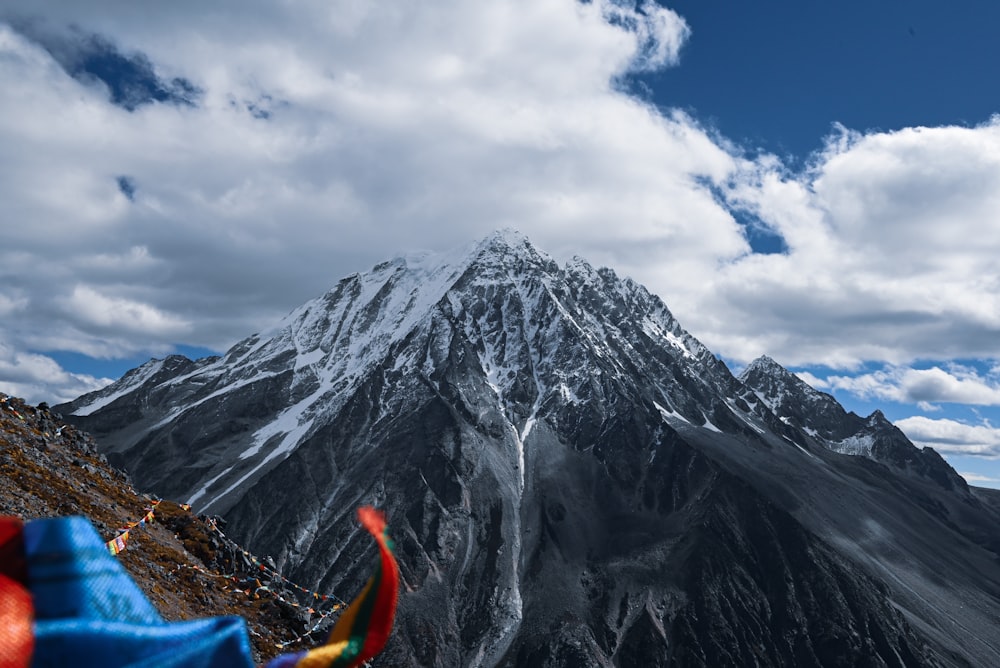 a view of a snow covered mountain from the top of a hill