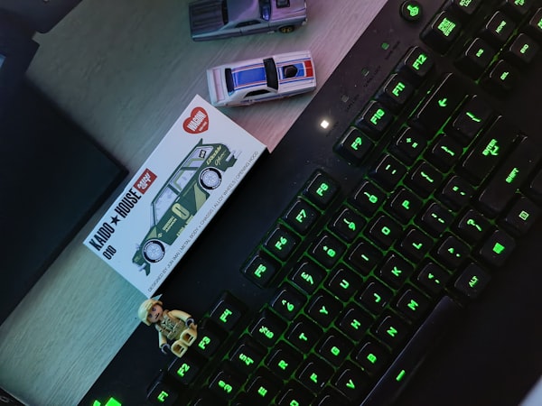 Close-up of a keyboard next to a smartphone on a desk