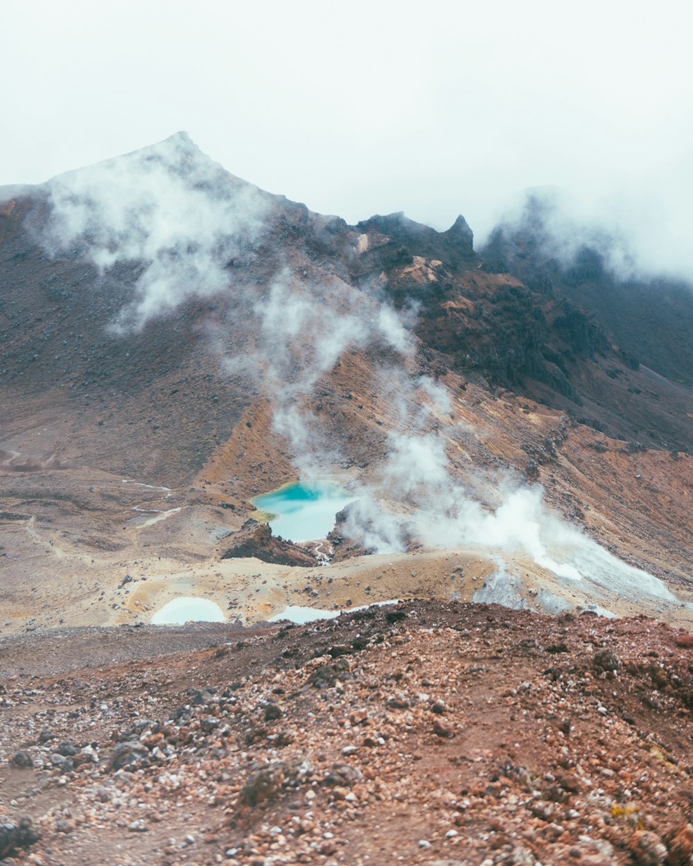 a view of a mountain with steam coming out of it