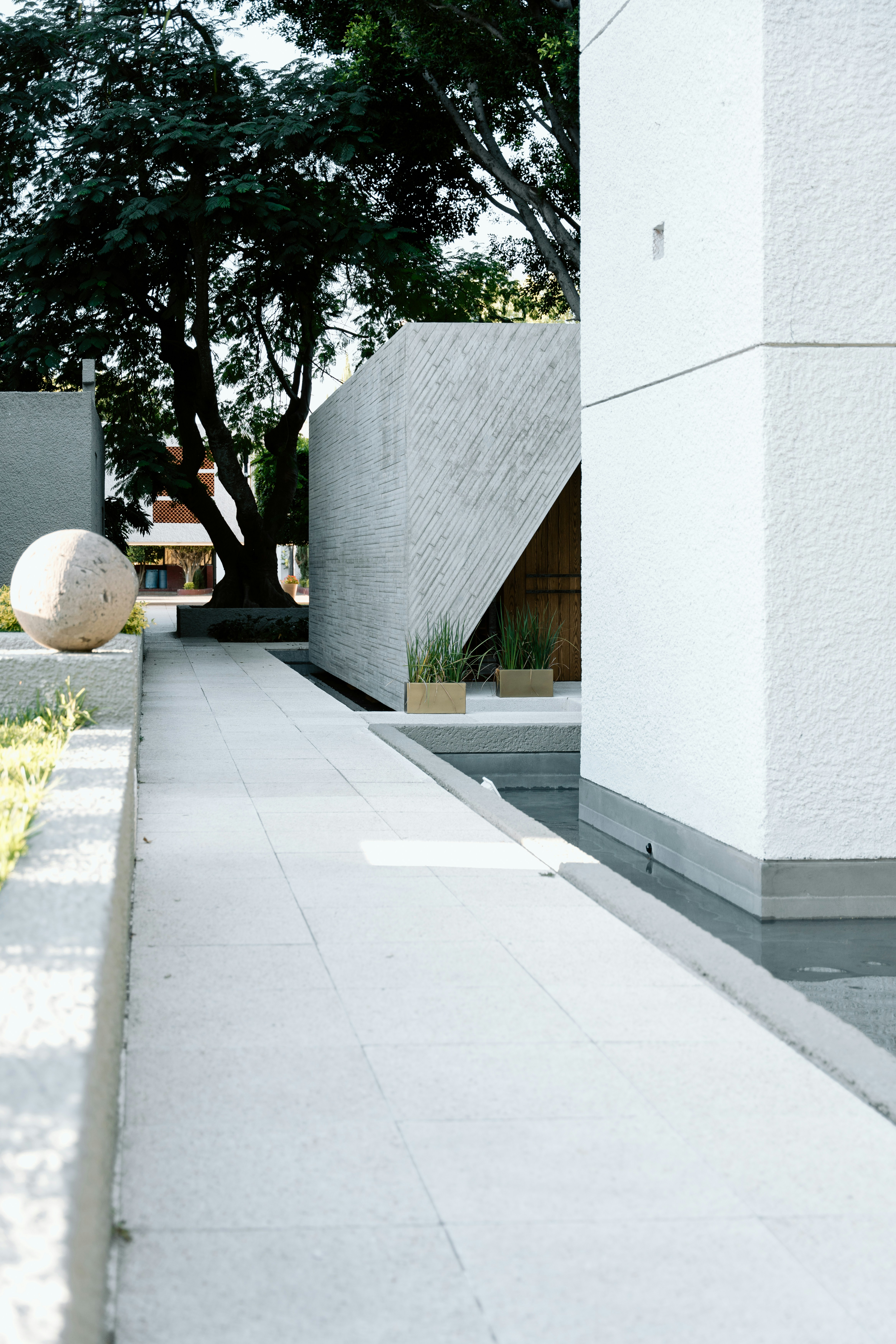 a sidewalk with a white ball on the side of it