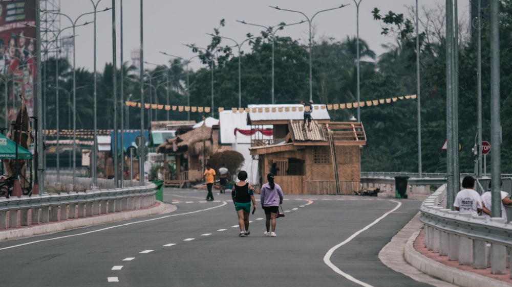 a couple of people that are walking down a street