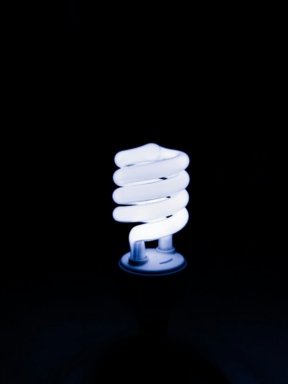 a white light bulb sitting on top of a table