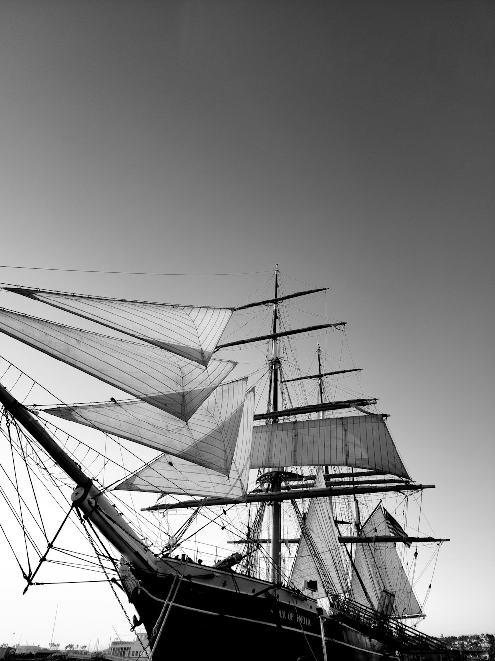 a black and white photo of a sail boat