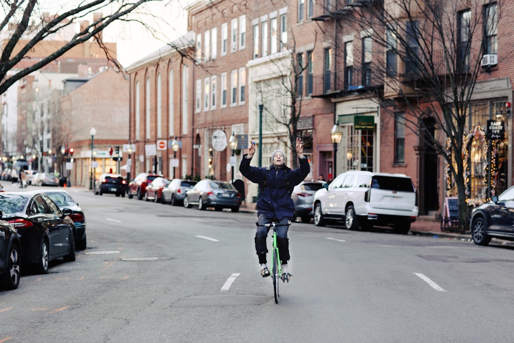 a person riding a bike on a city street