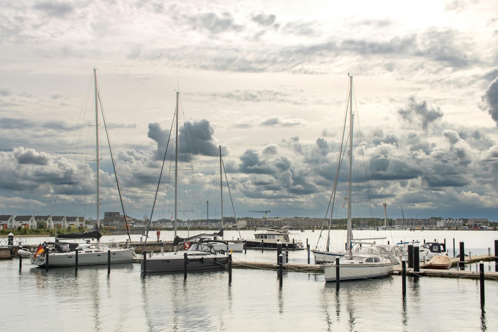 a harbor filled with lots of boats under a cloudy sky