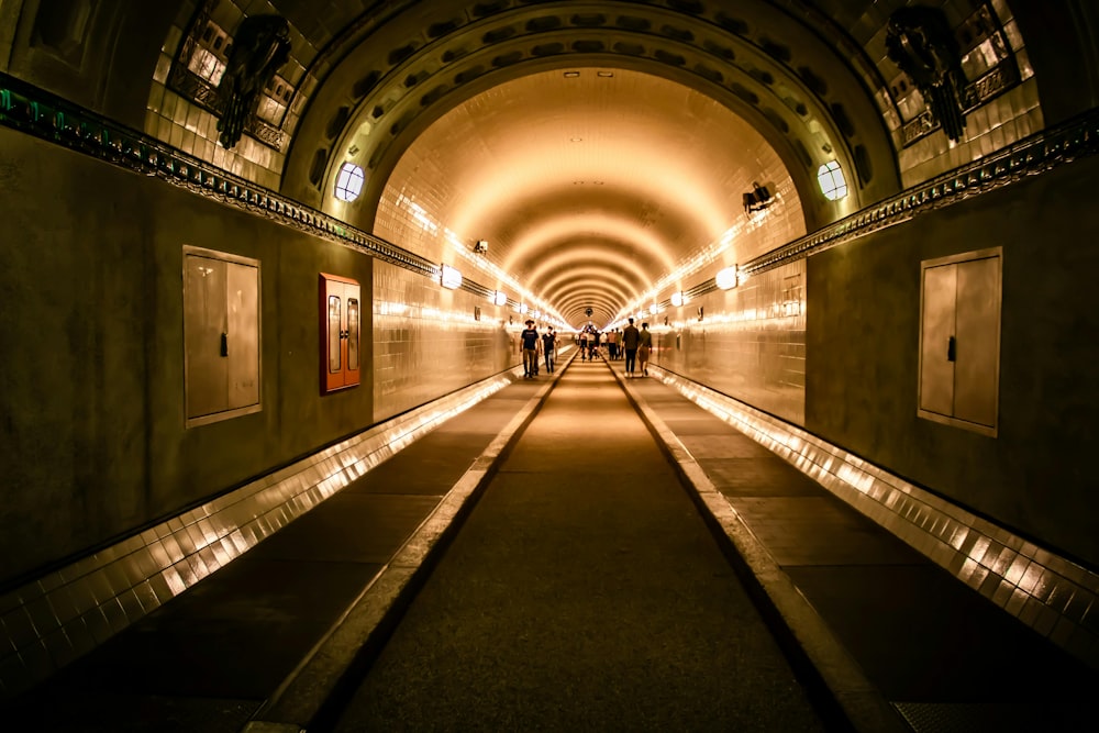 a long tunnel with people walking through it