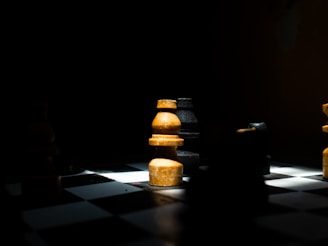 a black and white chess board with yellow pieces