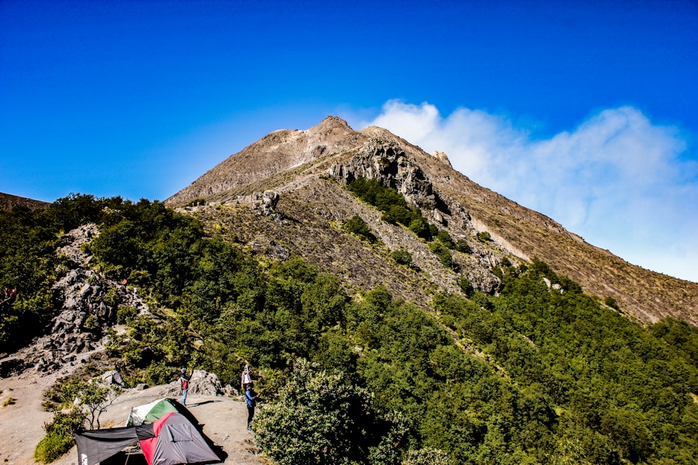 a tent pitched up on the side of a mountain