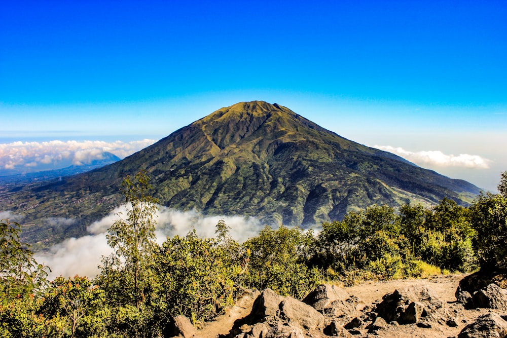 a view of a mountain with clouds in the sky