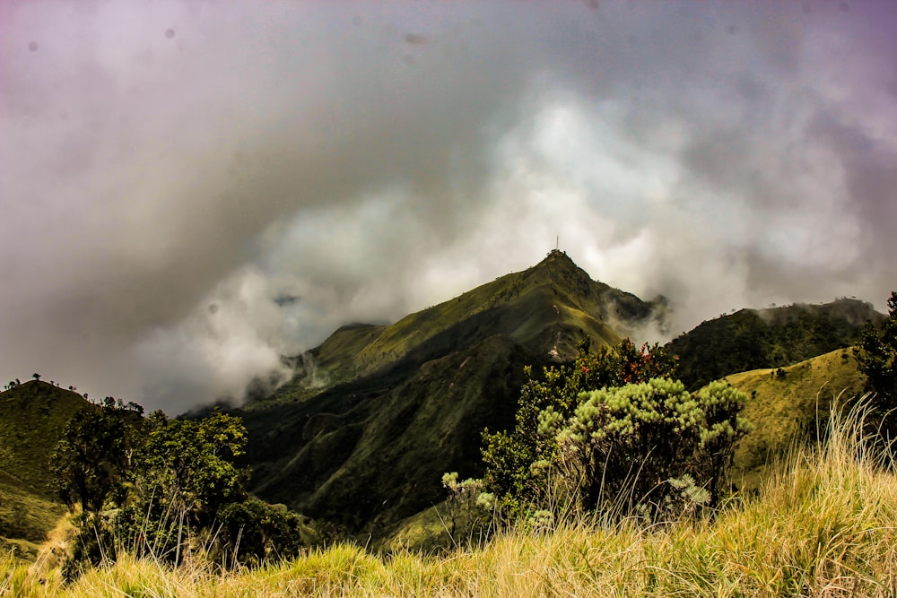 a view of a mountain with clouds in the sky