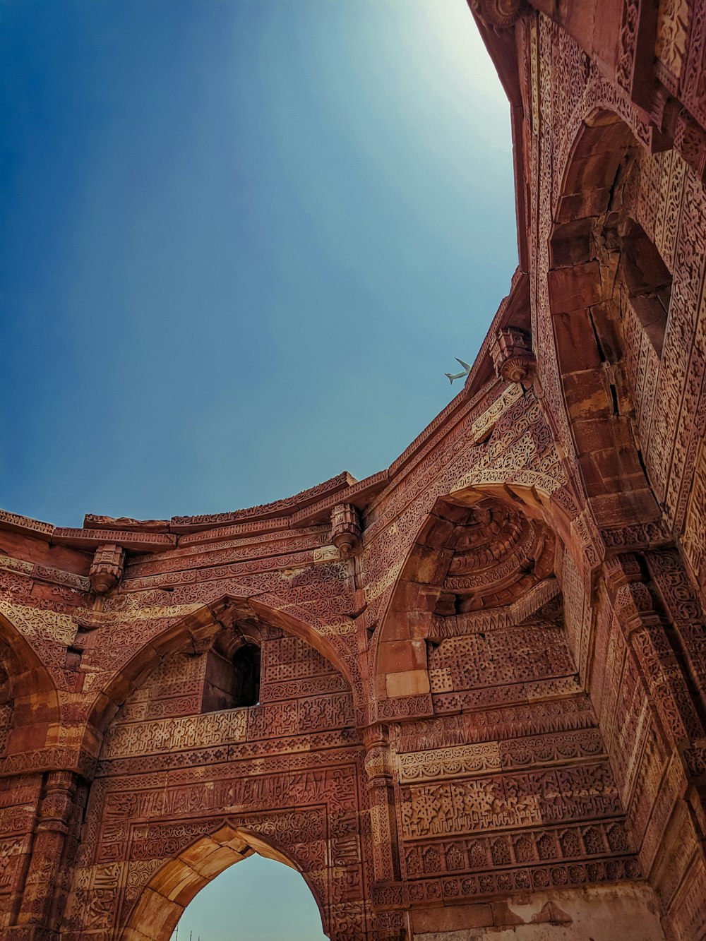 a very tall brick structure with a sky in the background