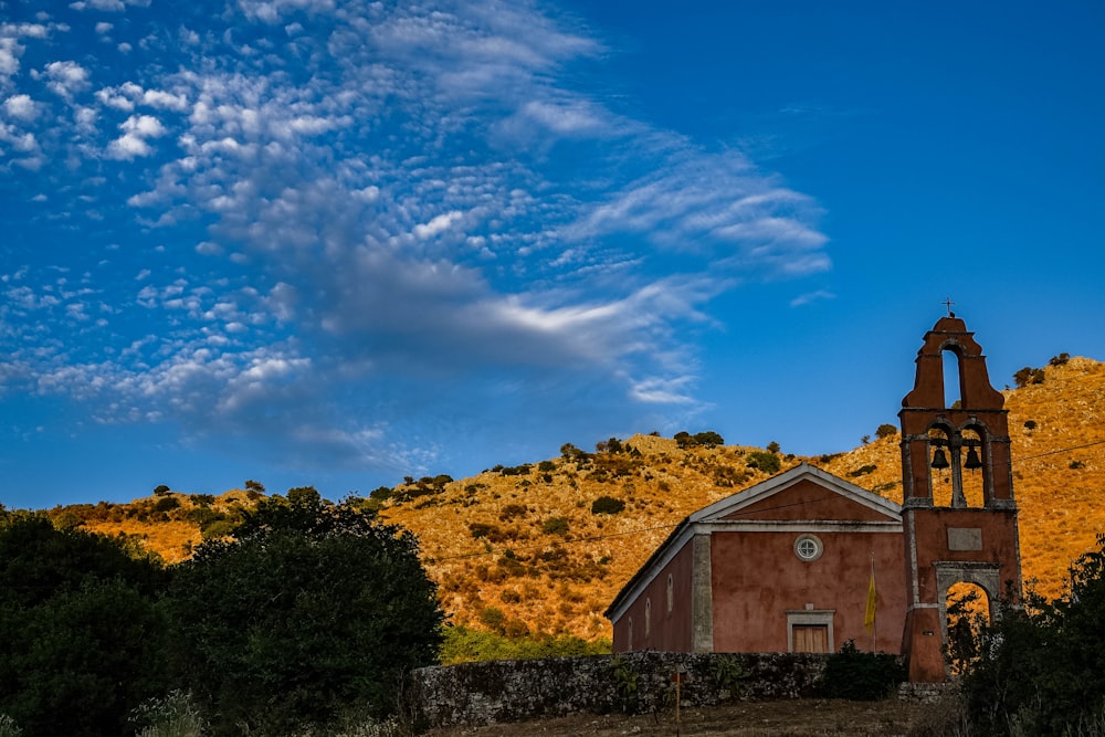 a church on a hill with a blue sky in the background