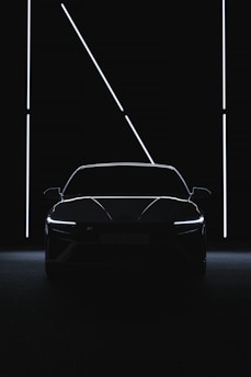 a car is shown in the dark with its lights on