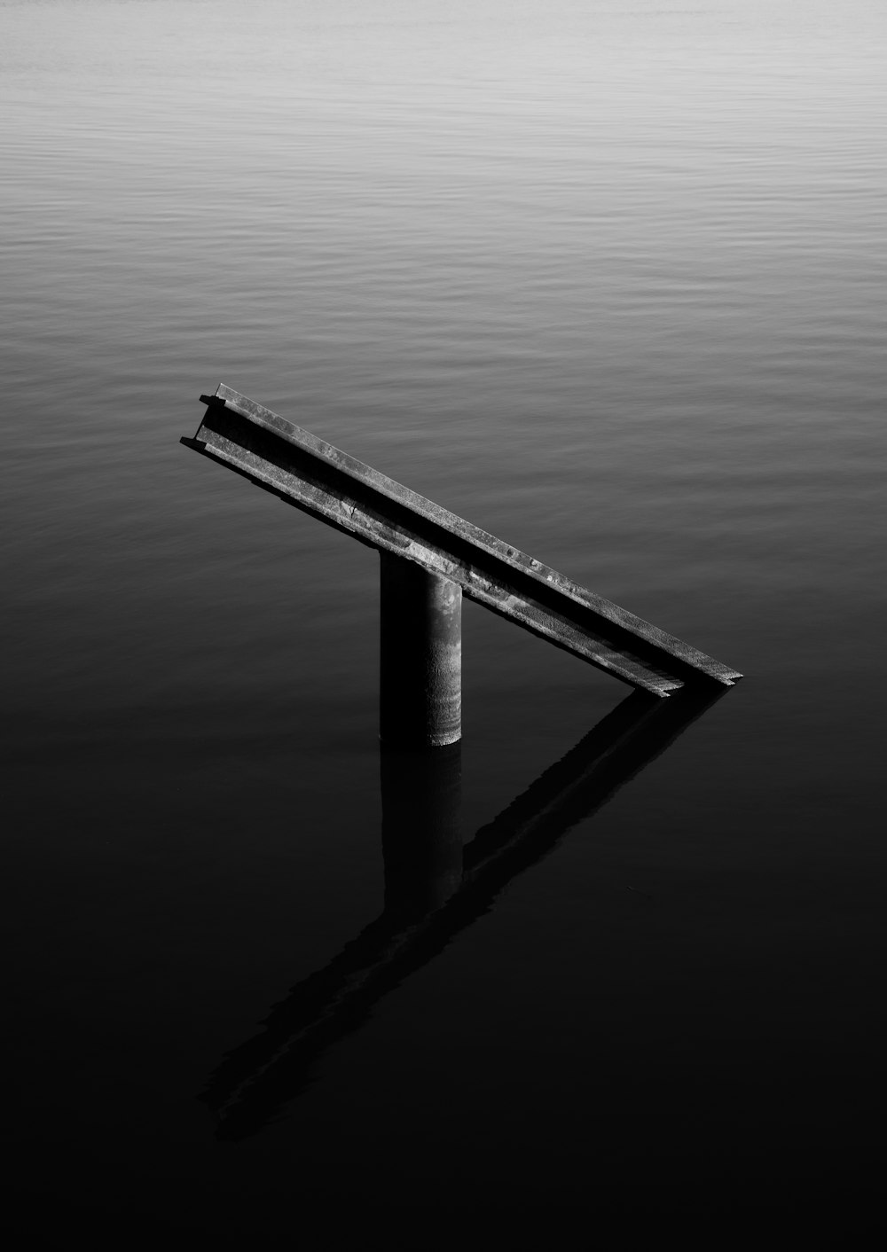 a bench sitting in the middle of a body of water