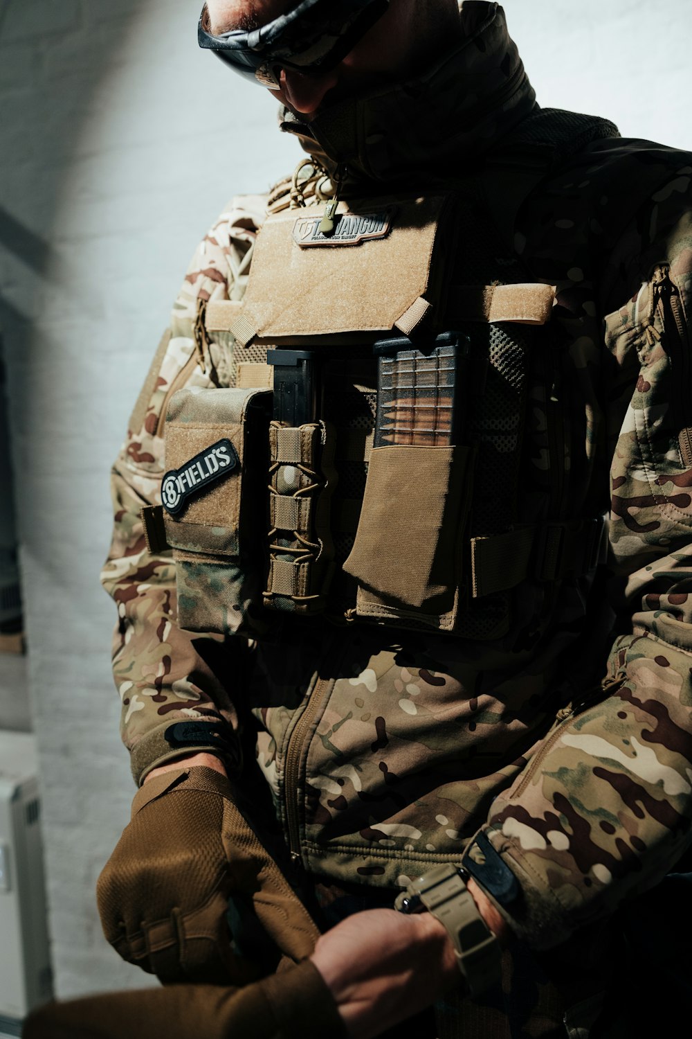 a man in a military uniform is holding something in his hand