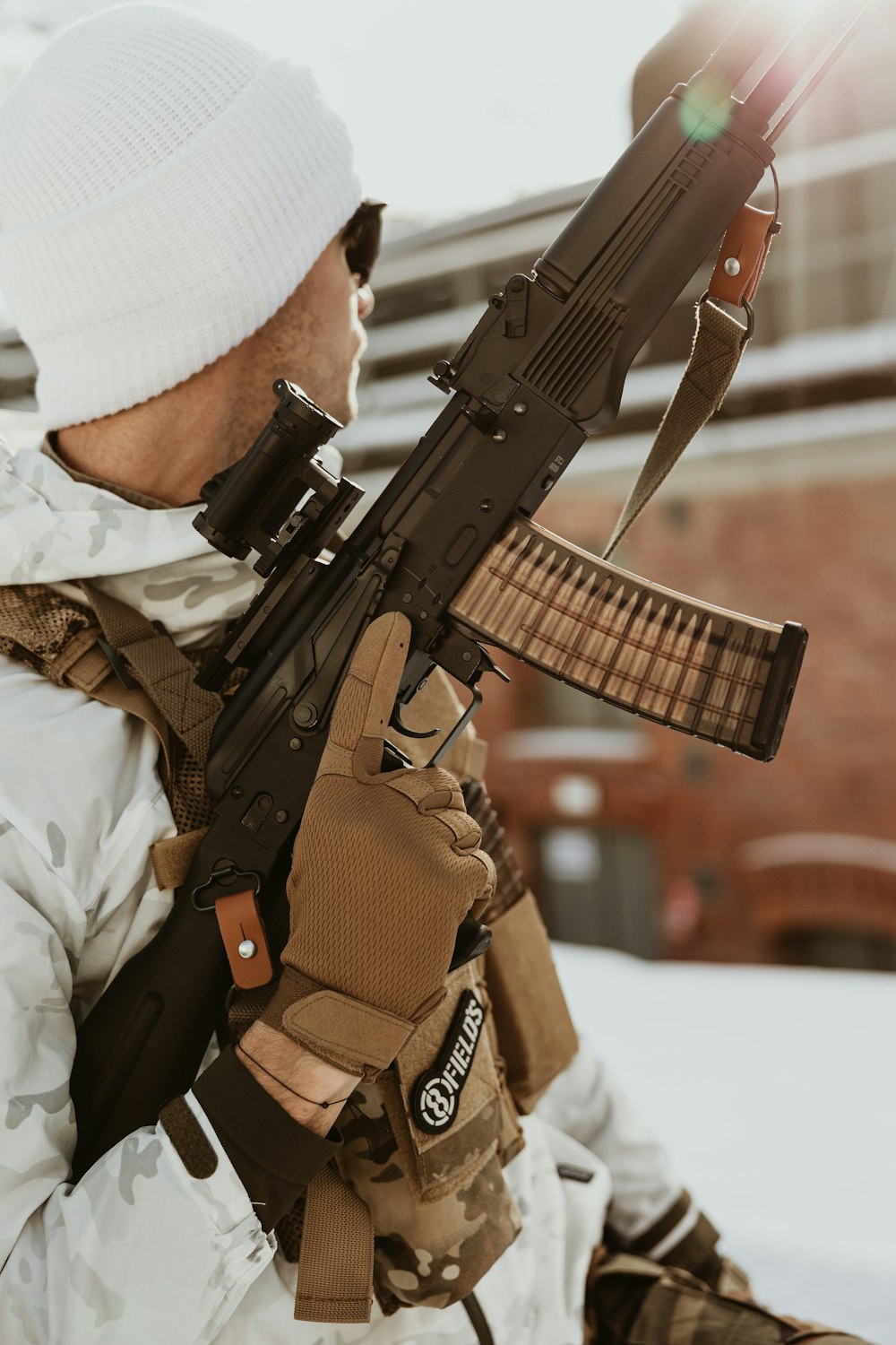 a man holding a rifle in his right hand