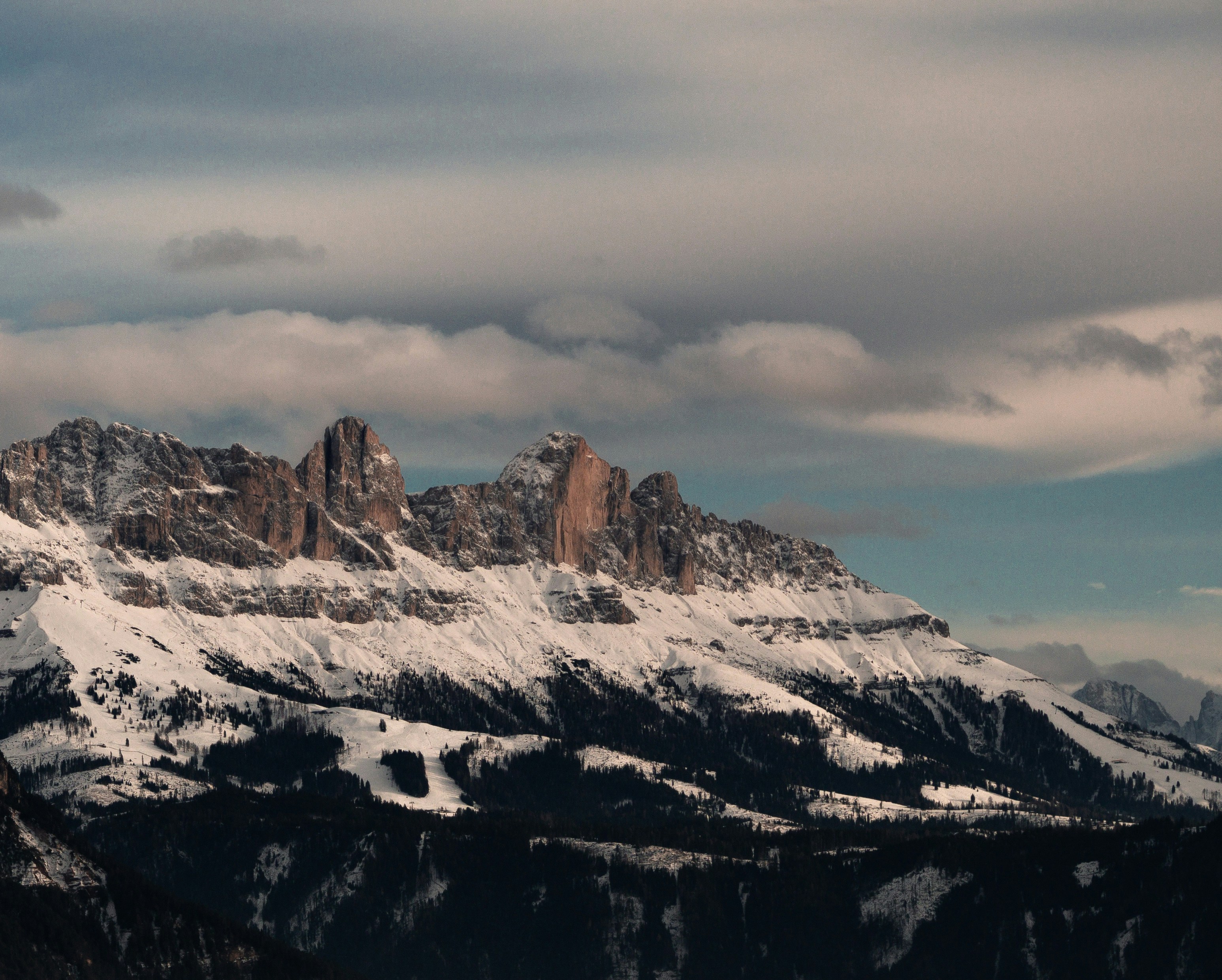 A snow covered mountain range under a cloudy sky photo – Free Dolomite ...