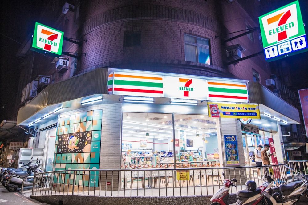 a gas station with motorcycles parked outside at night