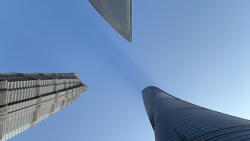 looking up at two tall skyscrapers in a city