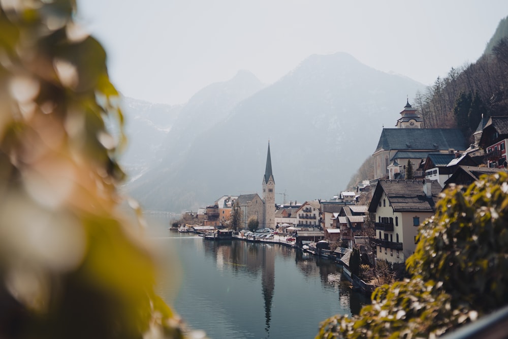 a small town on a lake surrounded by mountains