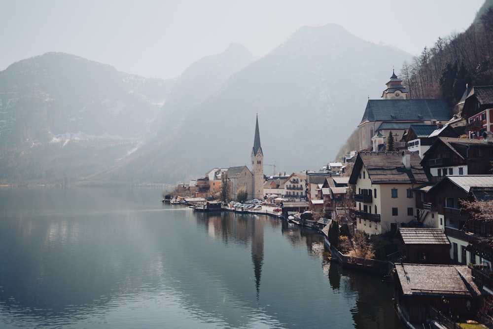 a village on a lake surrounded by mountains