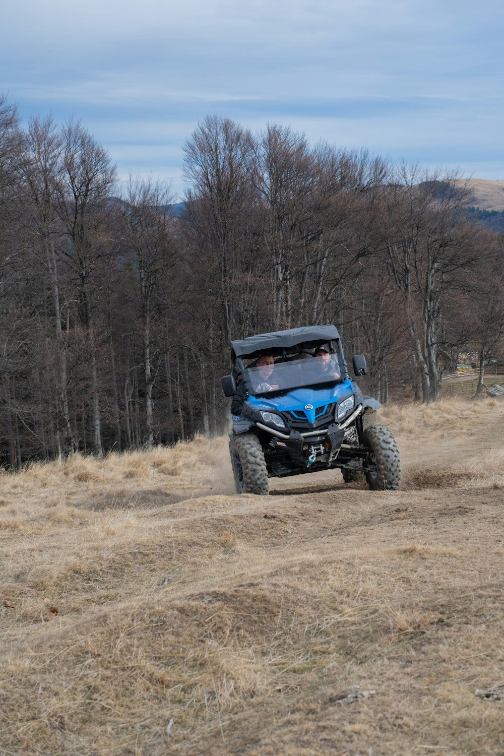 a person riding a buggy on a dirt road