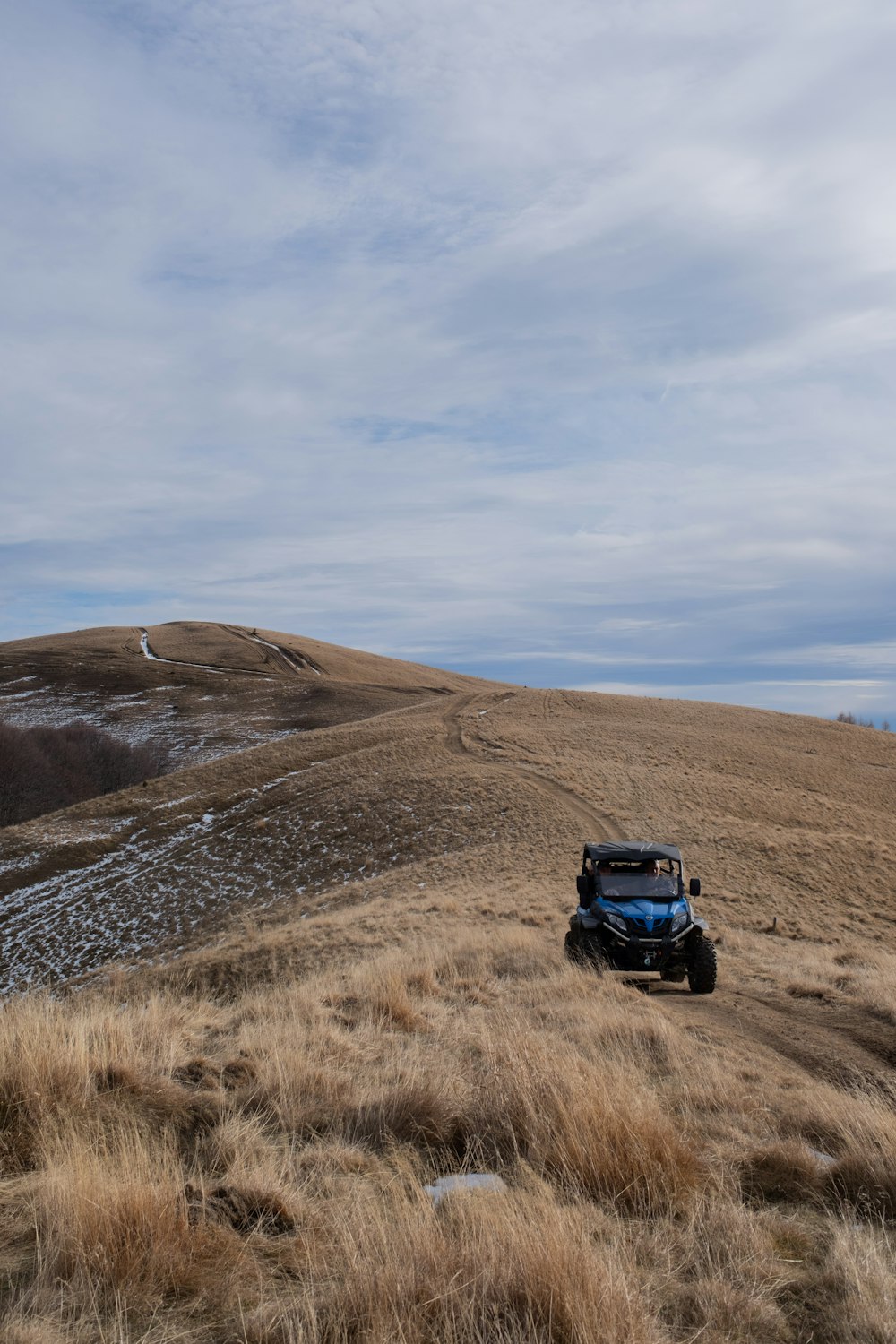 a truck is parked on the side of a hill