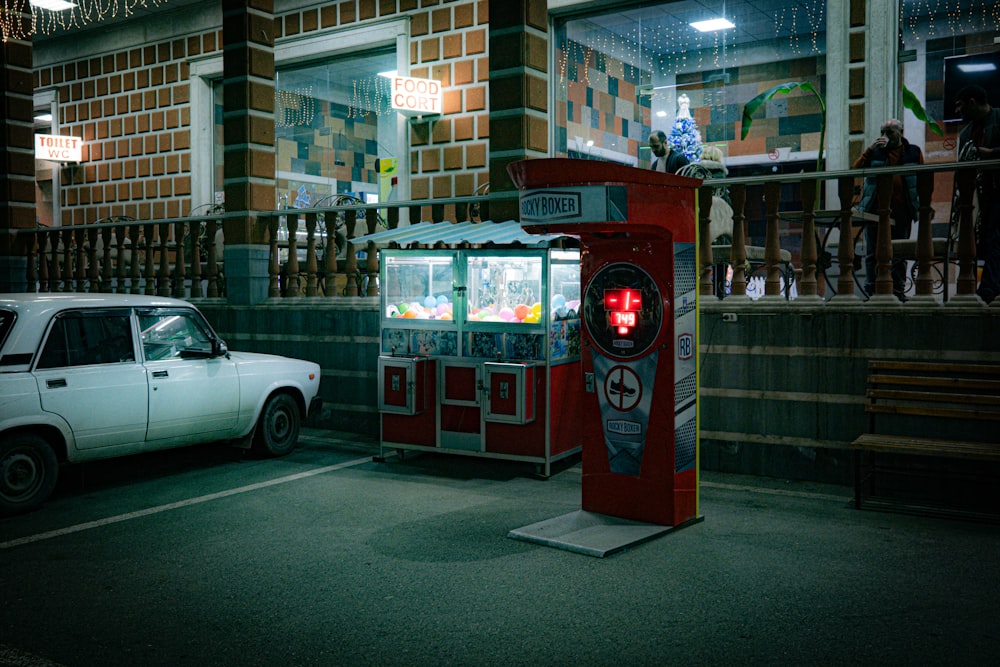 a car is parked in front of a vending machine