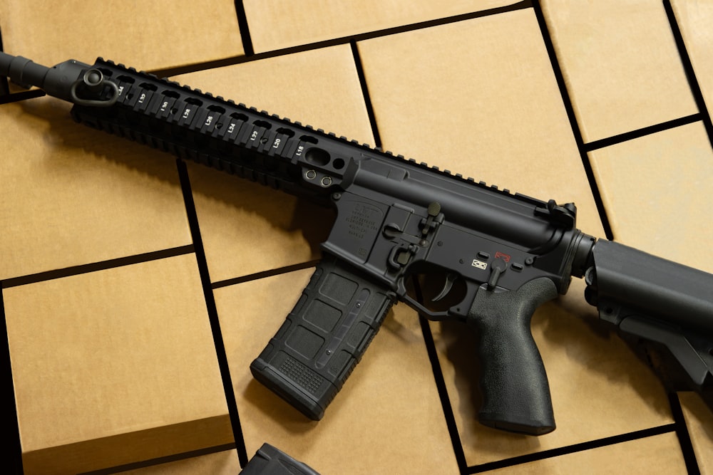 a black gun laying on a tiled floor