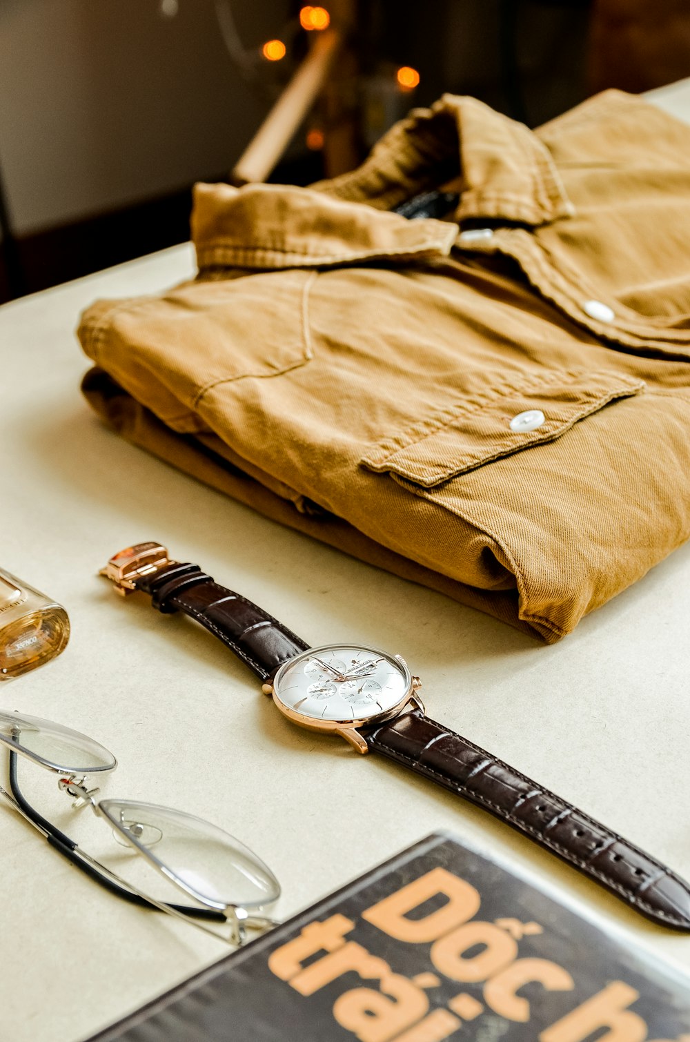 a pair of glasses and a watch on a table