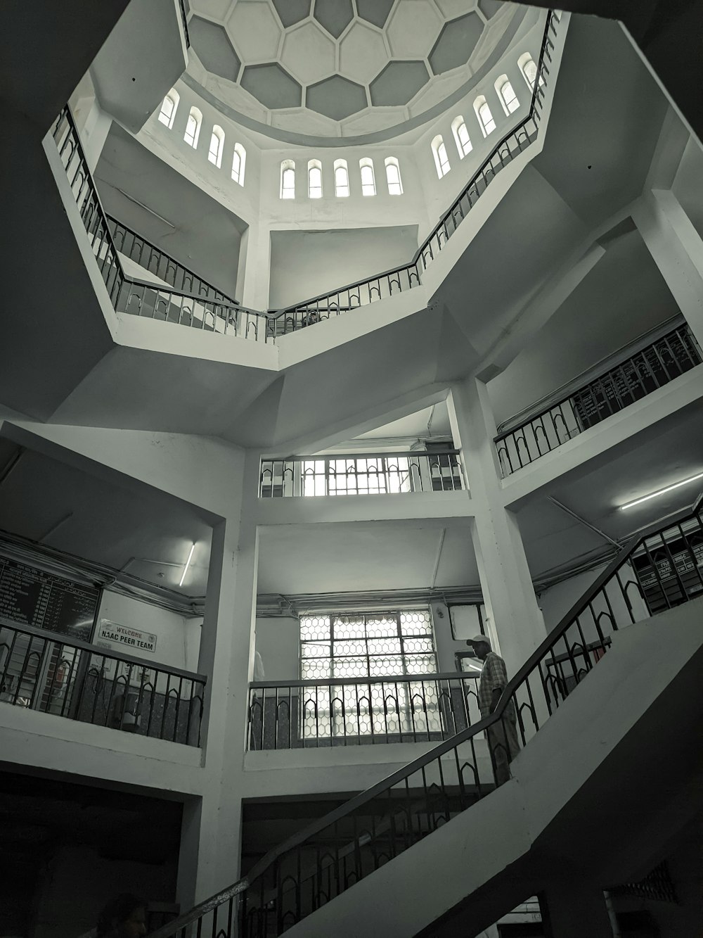 a black and white photo of a spiral staircase