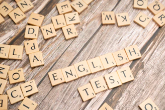 a close up of scrabble letters on a wooden surface