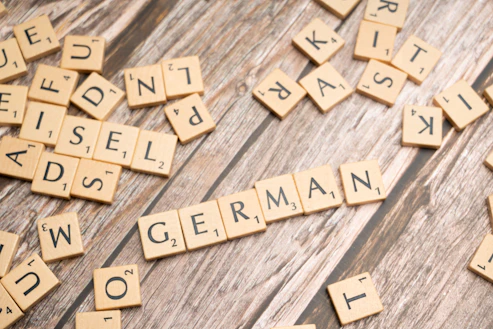 scrabble tiles spelling out words on a wooden surface