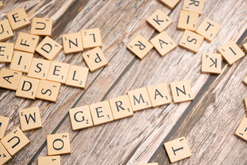 scrabble tiles spelling out words on a wooden surface