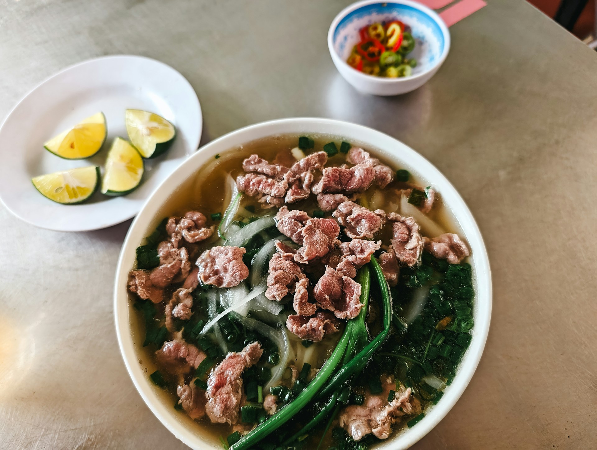 a bowl of food with meat and vegetables on a table